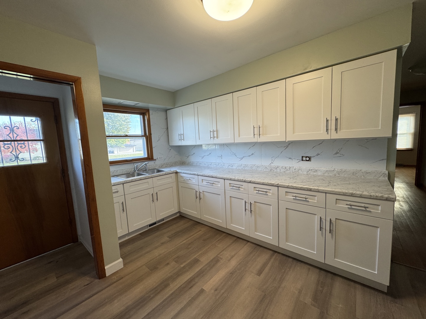 2621 Ridge Road Lansing, IL 60438 - Photo 6 of 20 a kitchen with granite countertop white cabinets and white appliances