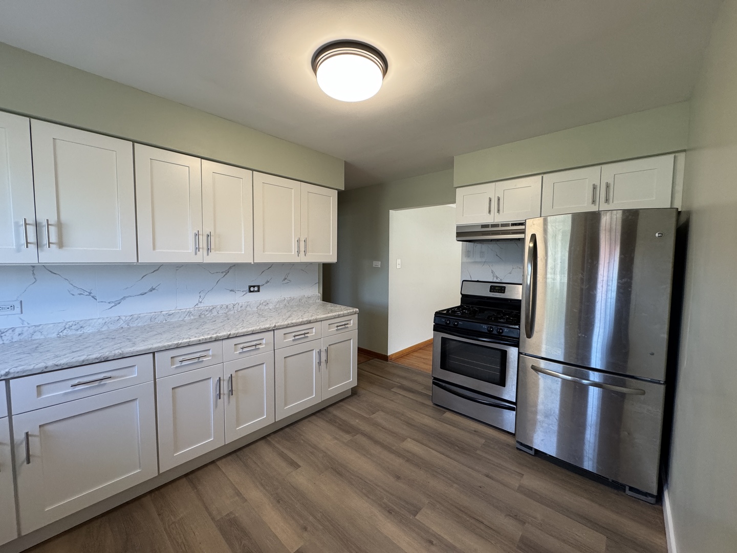 2621 Ridge Road Lansing, IL 60438 - Photo 8 of 20 a kitchen with granite countertop white cabinets and stainless steel appliances
