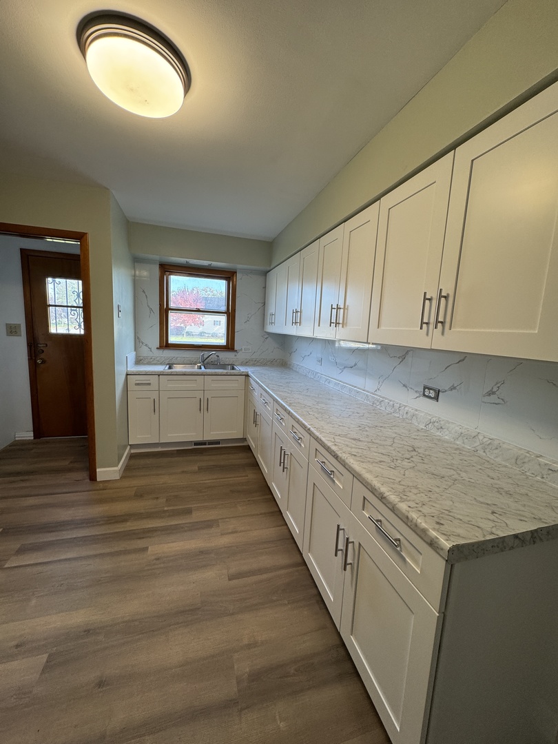 2621 Ridge Road Lansing, IL 60438 - Photo 9 of 20 an empty room with wooden floor and windows