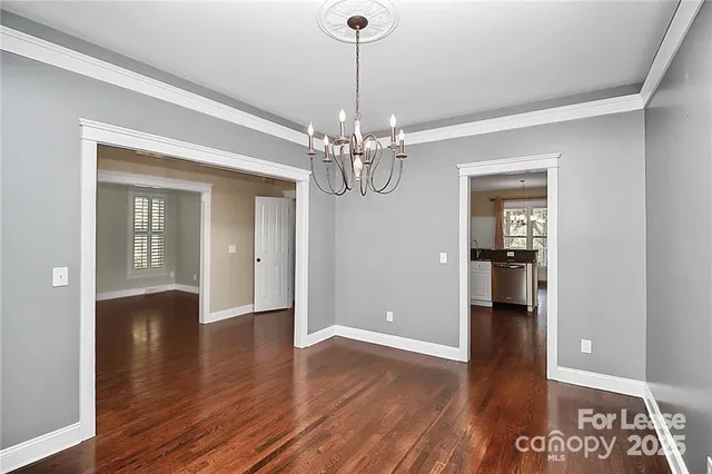 a view of a room with wooden floor chandelier and entryway