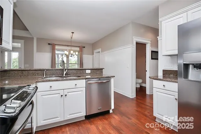 a kitchen with a sink stove and refrigerator