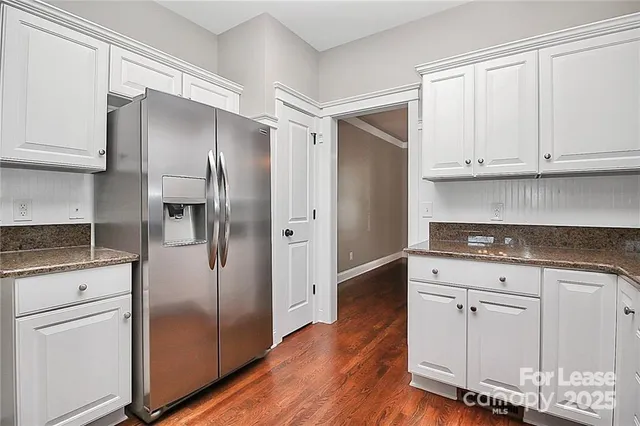 a kitchen with cabinets stainless steel appliances and a counter space