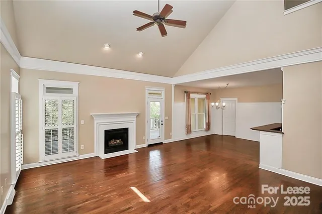 a view of empty room with wooden floor and fireplace