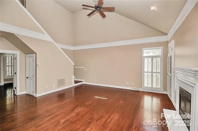 wooden floor in an empty room with a fireplace