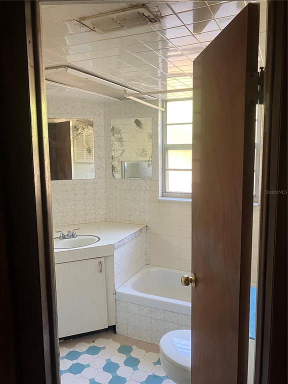 8428 Anay Court New Port Richey, FL 34653 - Photo 11 of 31 a bathroom with a sink toilet and shower