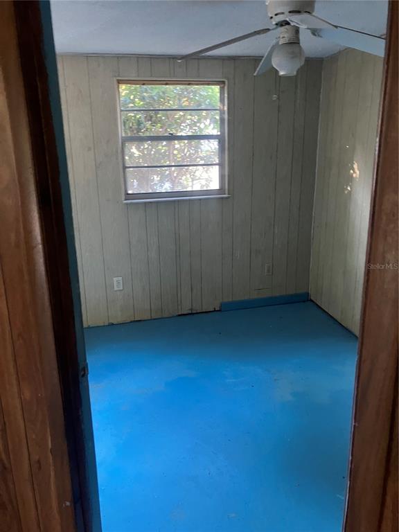 8428 Anay Court New Port Richey, FL 34653 - Photo 16 of 31 wooden floor in an empty room with a window