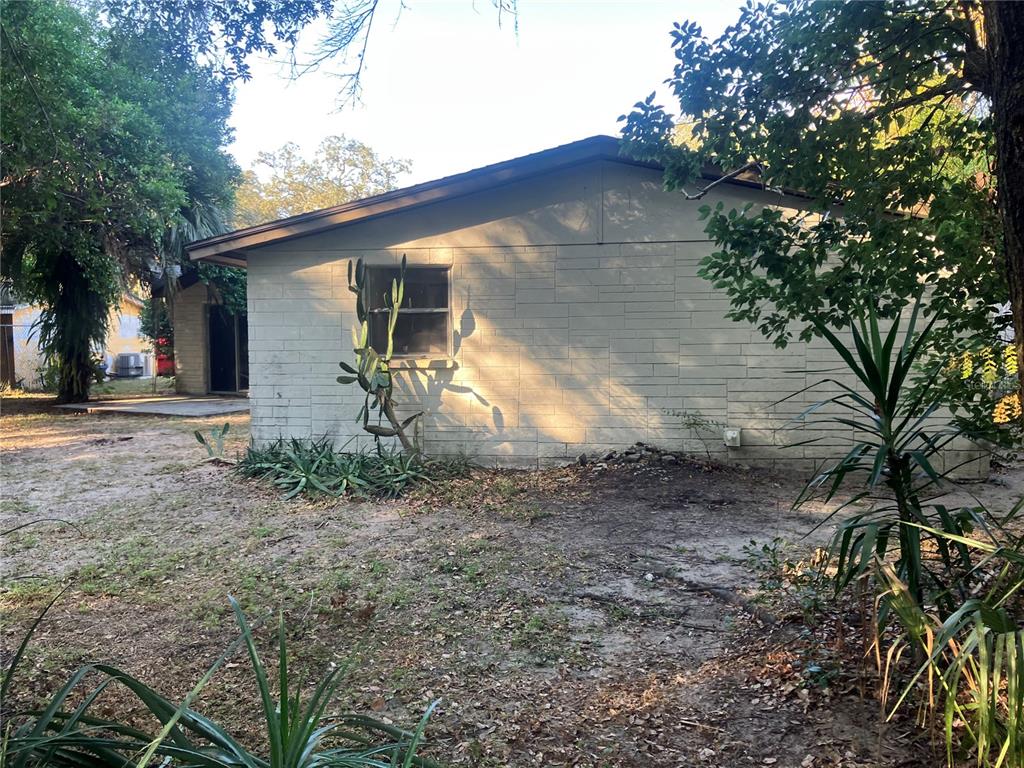 8428 Anay Court New Port Richey, FL 34653 - Photo 26 of 31 a backyard of a house with lots of green space