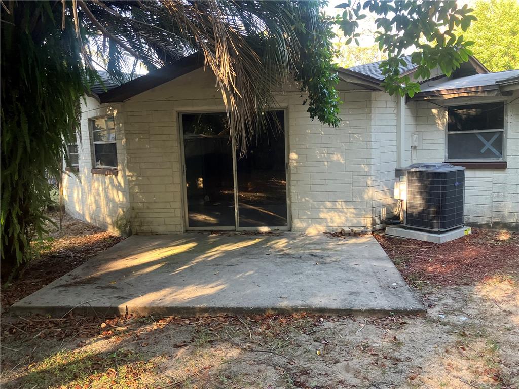 8428 Anay Court New Port Richey, FL 34653 - Photo 29 of 31 a view of a brick house with a large tree