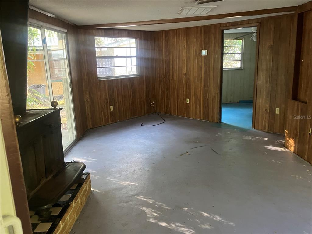 8428 Anay Court New Port Richey, FL 34653 - Photo 6 of 31 wooden floor and window in an empty room