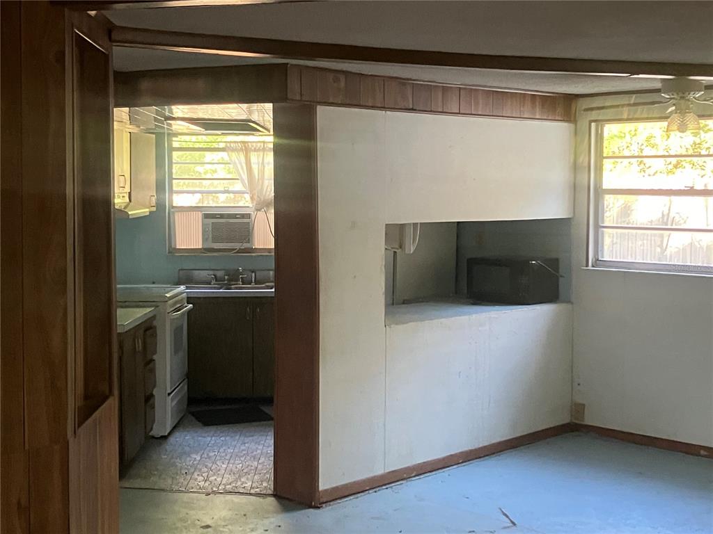 8428 Anay Court New Port Richey, FL 34653 - Photo 8 of 31 a kitchen with a refrigerator and a stove