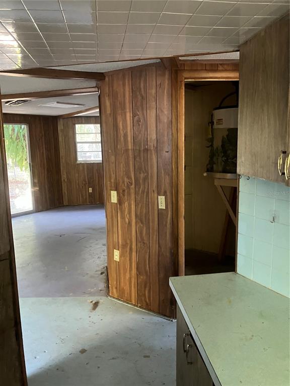 8428 Anay Court New Port Richey, FL 34653 - Photo 10 of 31 an entryway view with wooden floor and cabinet