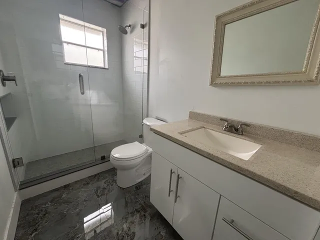 a view of a hallway with a wooden door