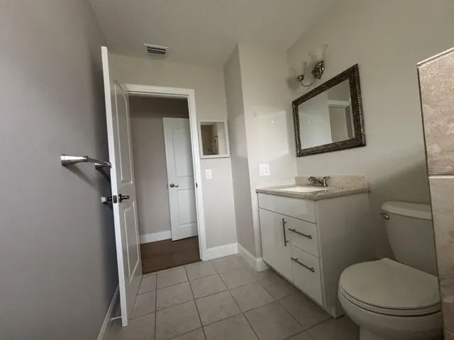 a bathroom with a sink a toilet and a shower