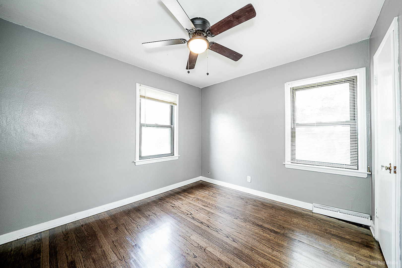 11 167th Street Calumet City, IL 60409 - Photo 7 of 20 an empty room with wooden floor ceiling fan and windows