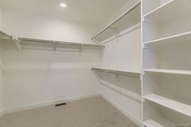 a picture of a room with a white wall and a refrigerator