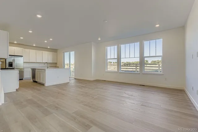 a kitchen with stainless steel appliances granite countertop a sink and a stove