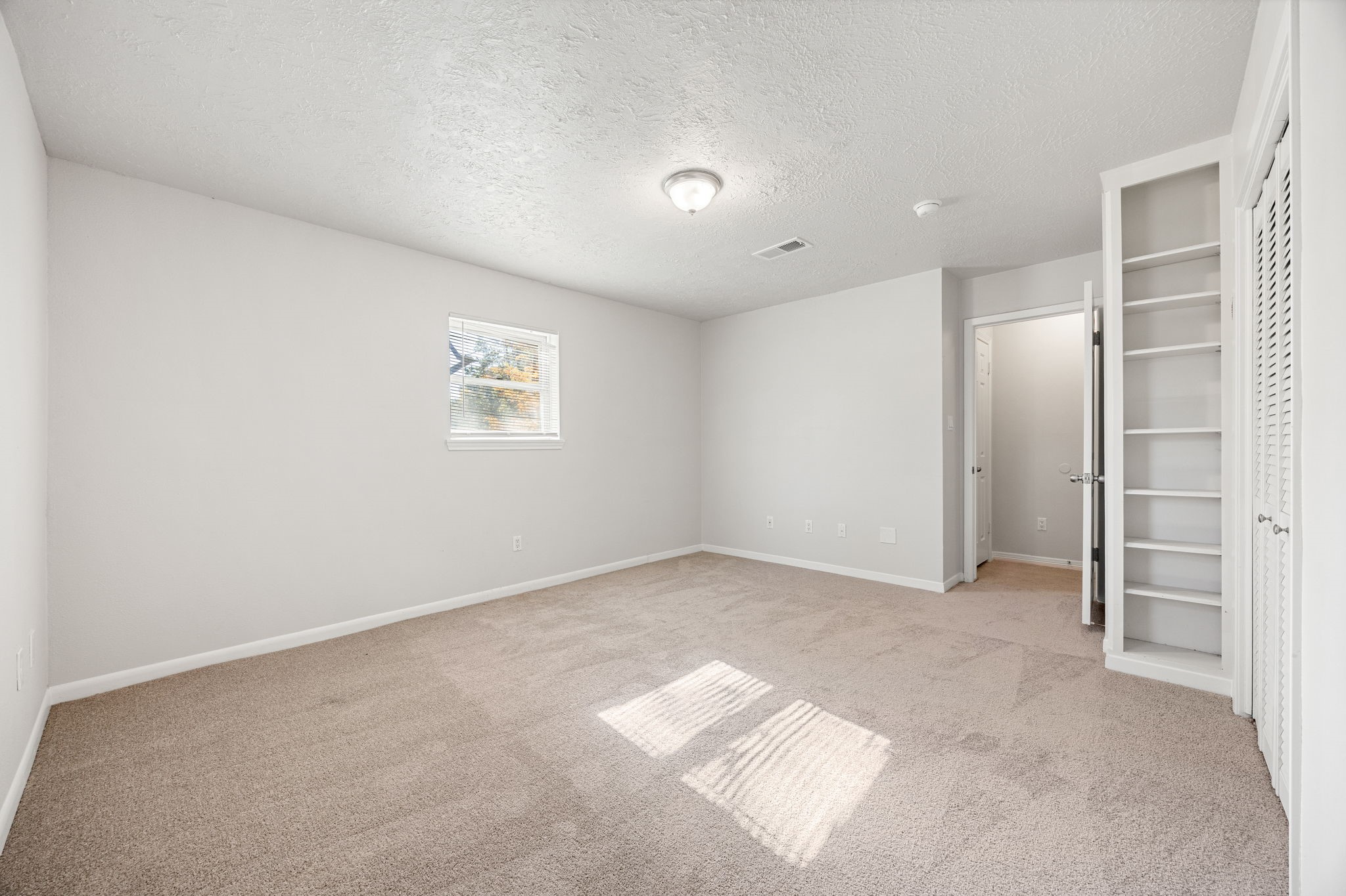 479 Brandon Road Conroe, TX 77302 - Photo 25 of 42 an empty room with a cabinet and mirrors