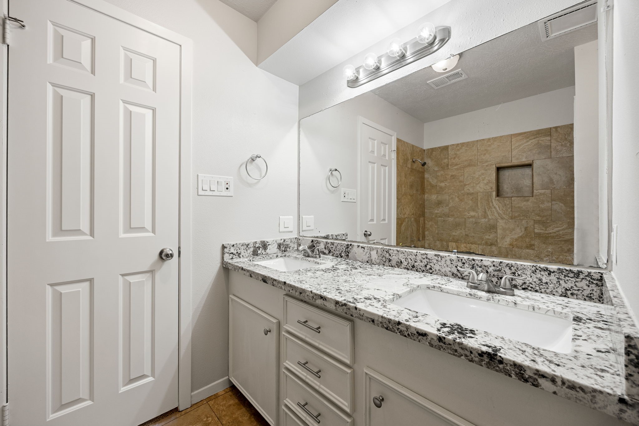 479 Brandon Road Conroe, TX 77302 - Photo 30 of 42 a bathroom with a granite countertop double vanity sink and mirror
