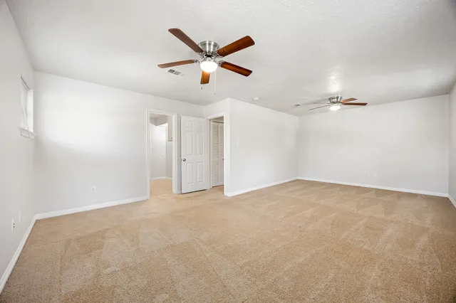 a view of a house with a yard and large tree