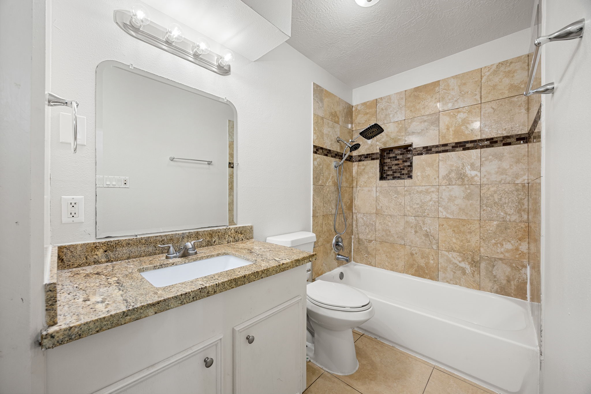 479 Brandon Road Conroe, TX 77302 - Photo 35 of 42 a bathroom with a granite countertop sink a toilet and shower