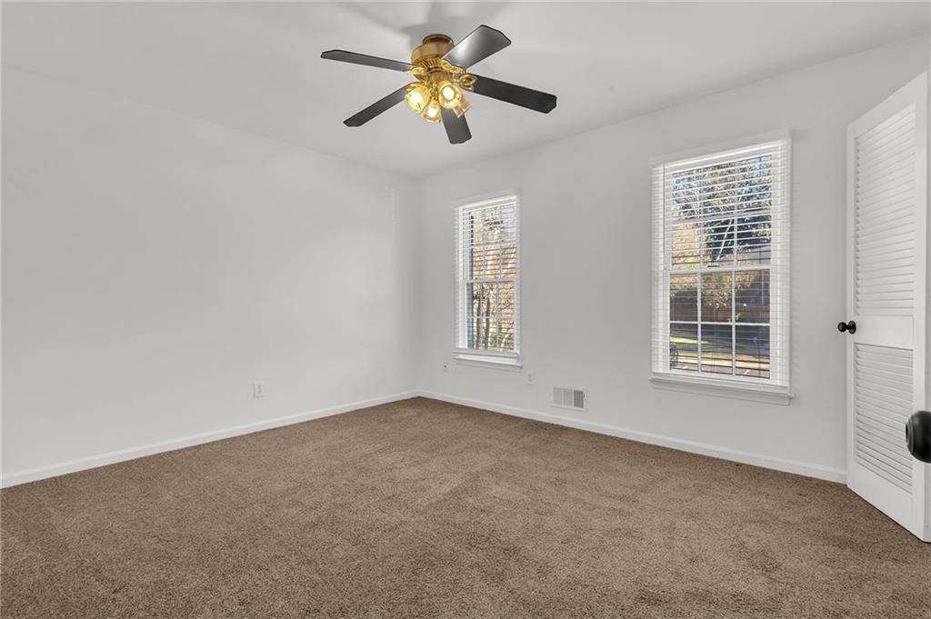 1101 Collier Road Northwest, Unit I2 Atlanta, GA 30318 - Photo 12 of 14 a view of empty room with ceiling fan