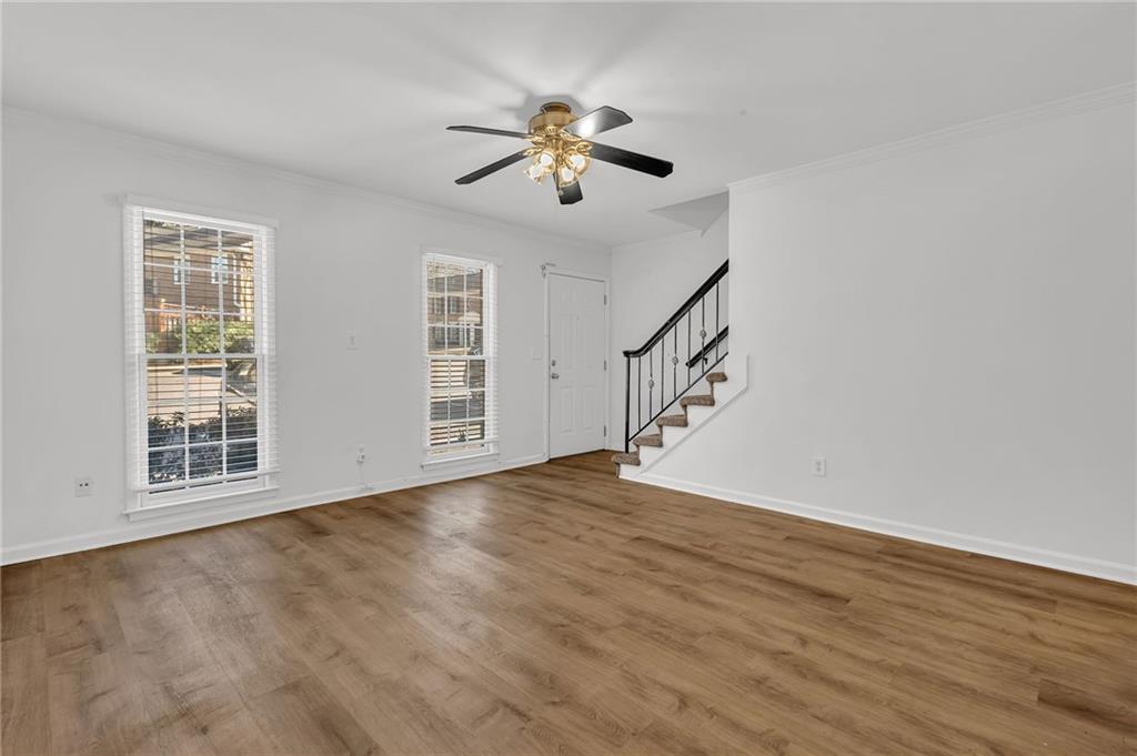 1101 Collier Road Northwest, Unit I2 Atlanta, GA 30318 - Photo 4 of 14 a view of an empty room with wooden floor and a window