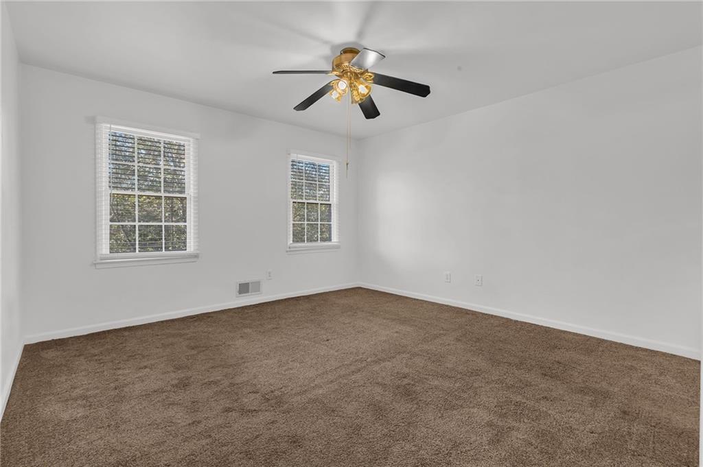 1101 Collier Road Northwest, Unit I2 Atlanta, GA 30318 - Photo 8 of 14 an empty room with windows and fan
