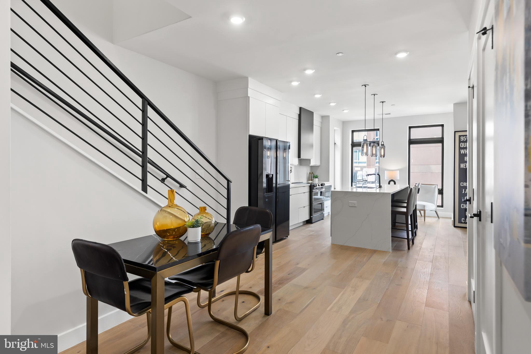 1208 M Street Northwest, Unit 61 Washington, DC 20005 - Photo 11 of 39 a open kitchen with a table and chairs