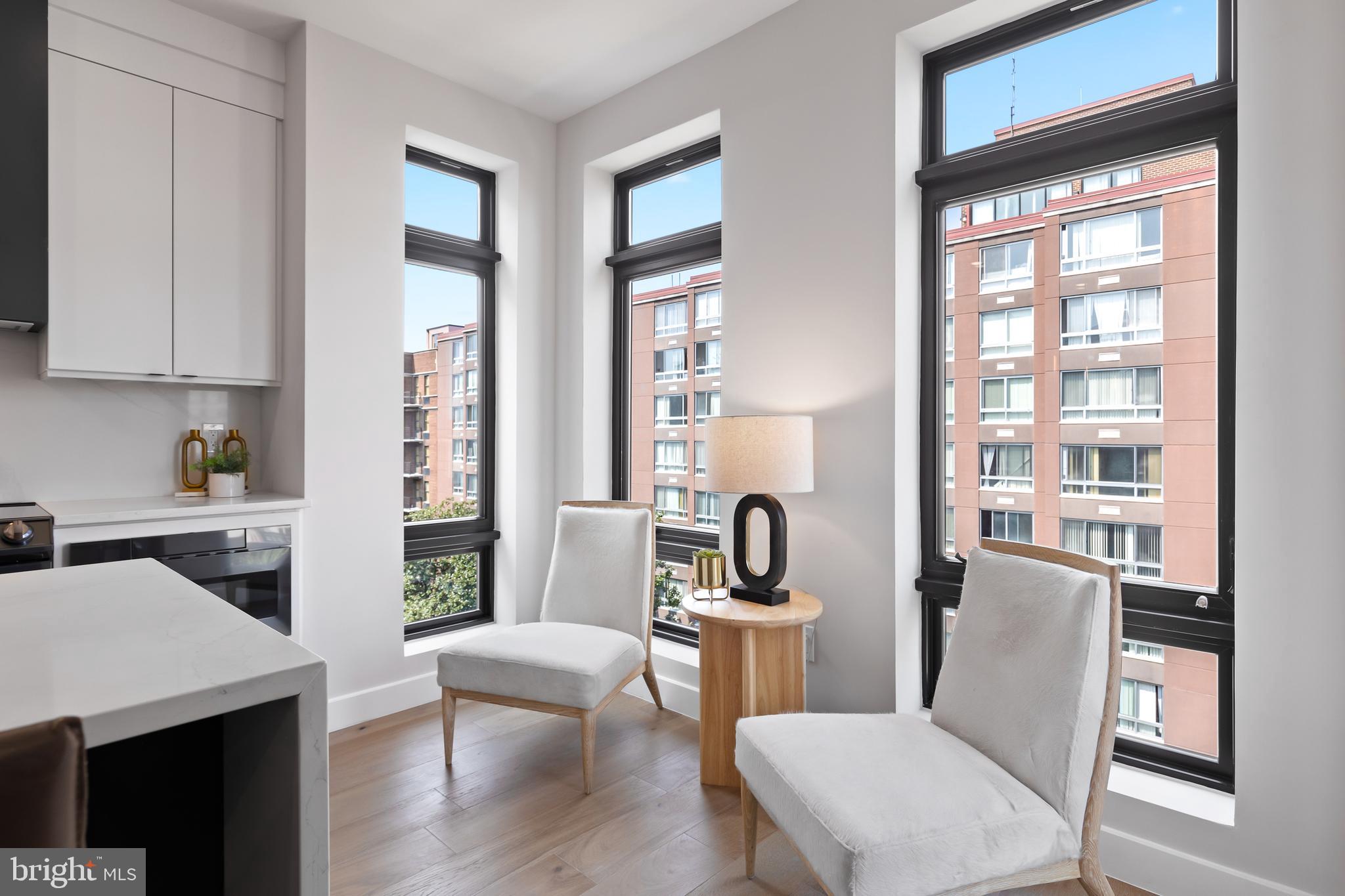 1208 M Street Northwest, Unit 61 Washington, DC 20005 - Photo 16 of 39 a view of a dining room with furniture a rug and wooden floor