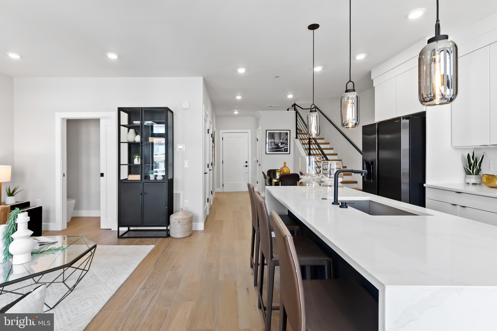 1208 M Street Northwest, Unit 61 Washington, DC 20005 - Photo 20 of 39 a kitchen with stainless steel appliances kitchen island a refrigerator and a wooden floor