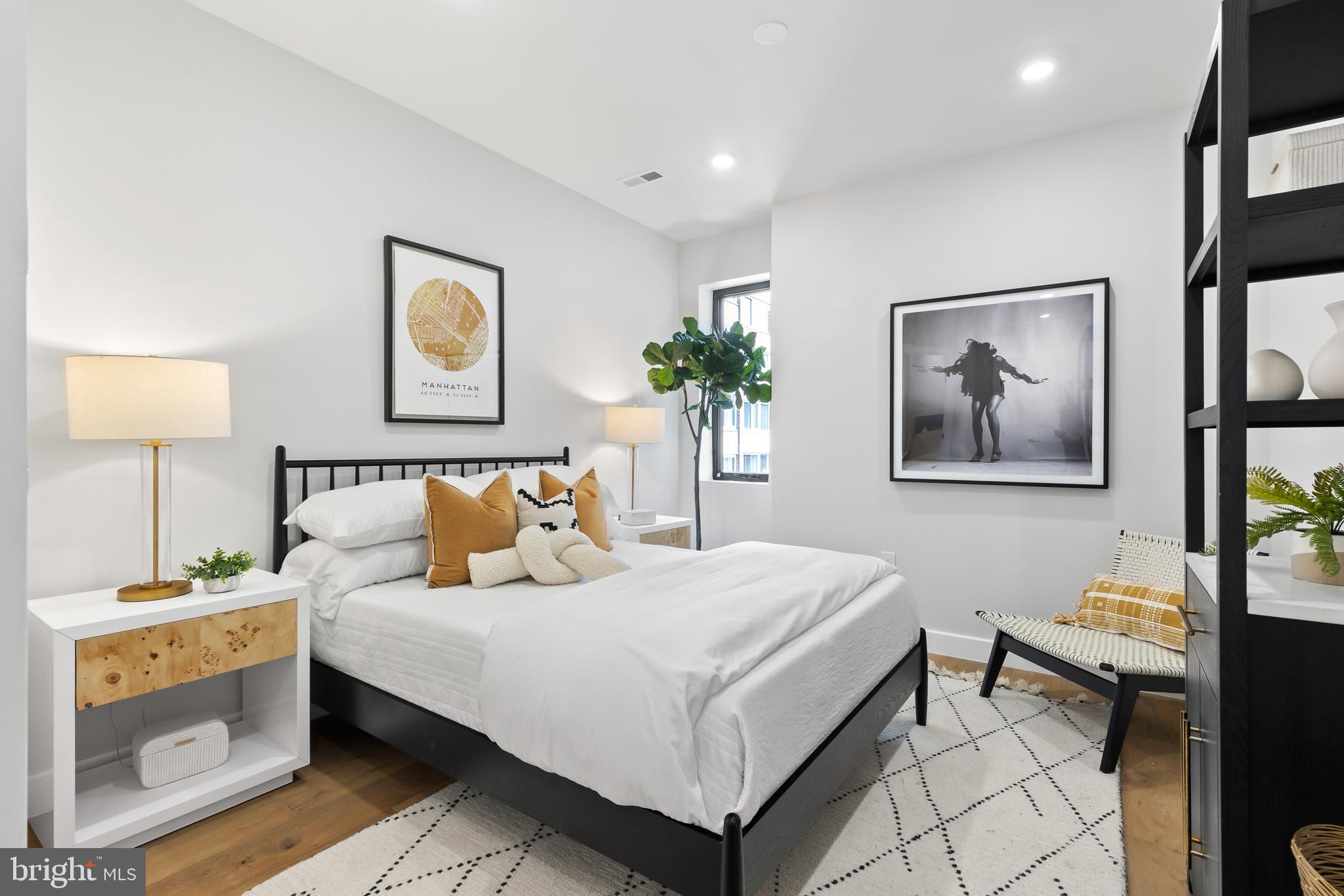 1208 M Street Northwest, Unit 61 Washington, DC 20005 - Photo 26 of 39 a bedroom with a bed and a painting on the wall