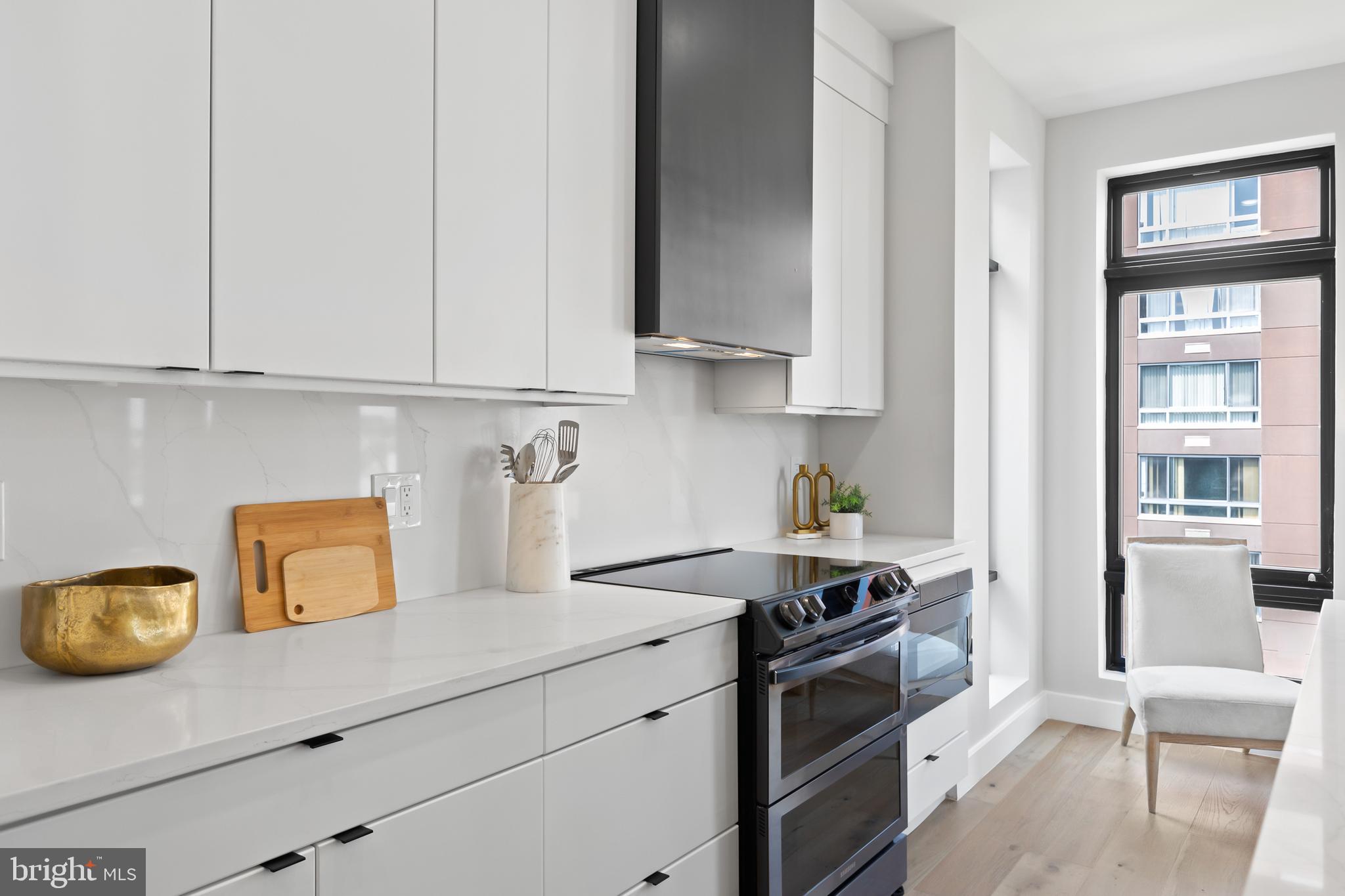 1208 M Street Northwest, Unit 61 Washington, DC 20005 - Photo 8 of 39 a kitchen with stainless steel appliances granite countertop a sink stove and refrigerator
