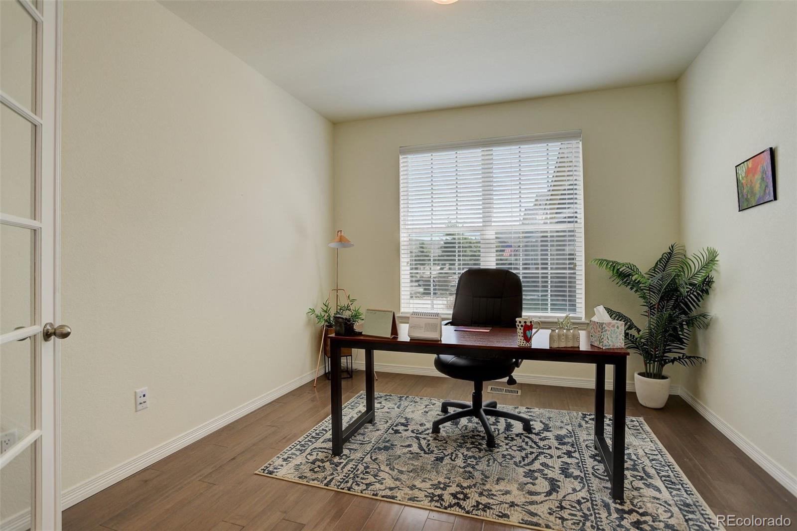 14747 Ulster Loop Thornton, CO 80602 - Photo 19 of 33 a view of a workspace with a window and lounge chair