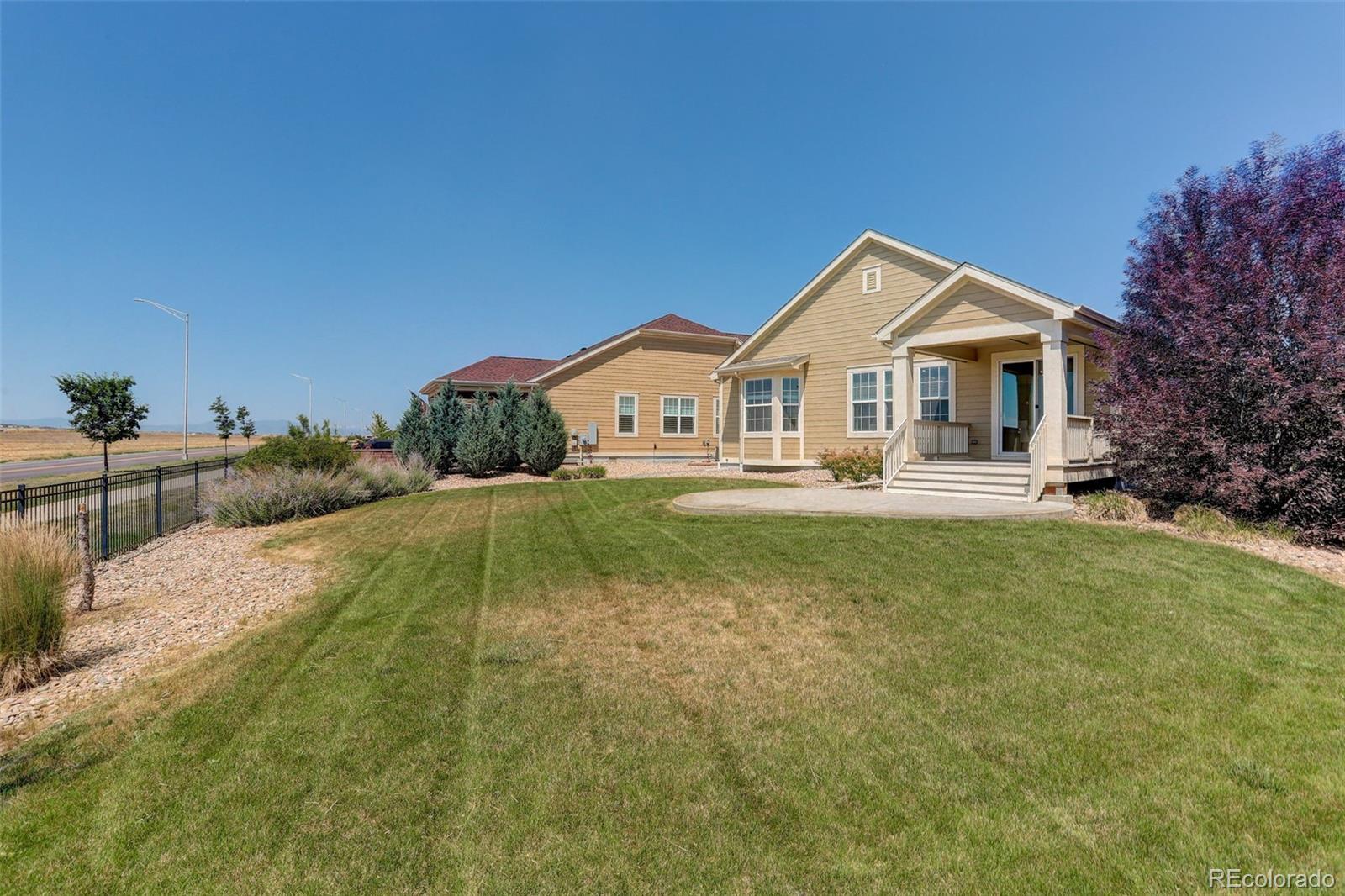 14747 Ulster Loop Thornton, CO 80602 - Photo 30 of 33 a front view of a house with a yard