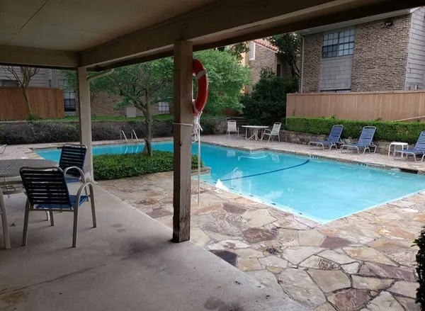 a view of a swimming pool with a patio