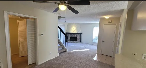 a view of a hallway to a livingroom with a fireplace