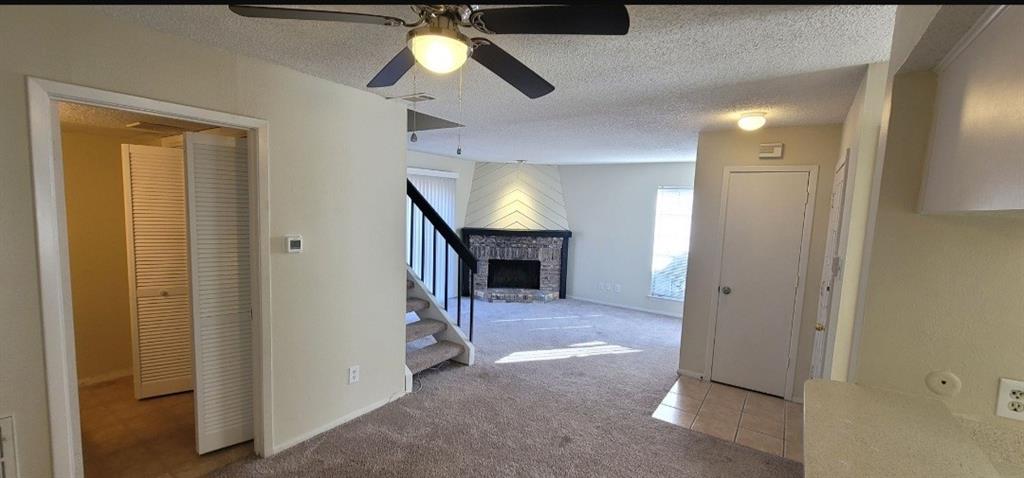 883 Waterfall Way Richardson, TX 75080 - Photo 5 of 26 a view of a hallway to a livingroom with a fireplace