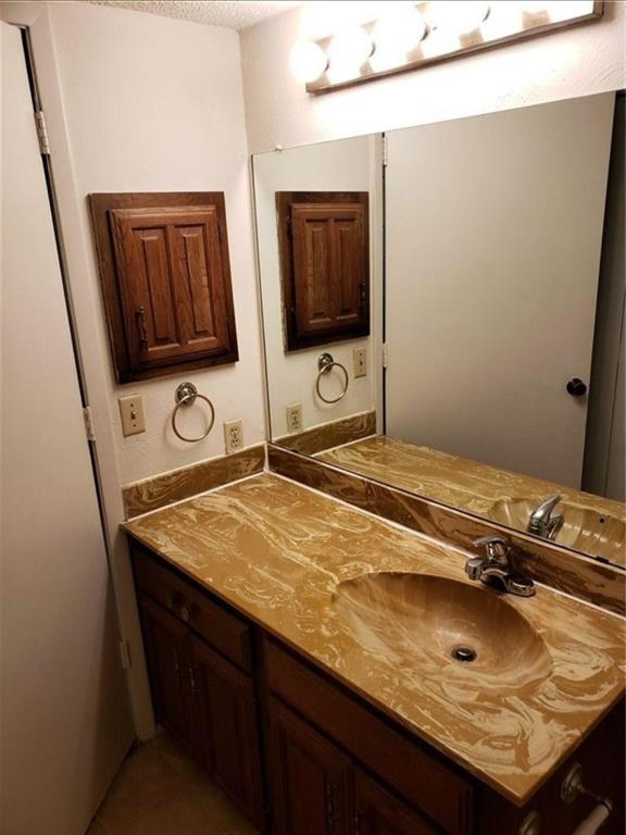 883 Waterfall Way Richardson, TX 75080 - Photo 6 of 26 a bathroom with a sink and a mirror