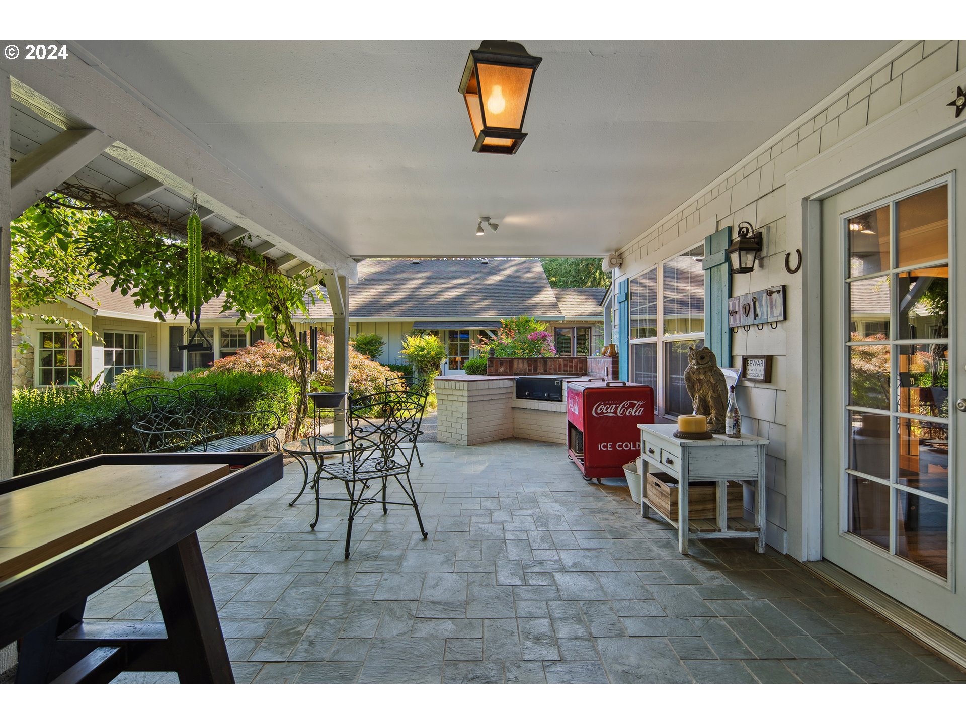 21545 Southwest Johnson Road West Linn, OR 97068 - Photo 29 of 43 a dining room with wooden floor and outdoor seating