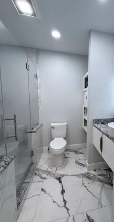 a bathroom with a toilet a sink and a mirror