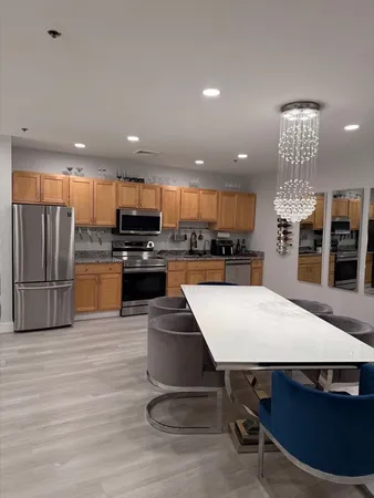a kitchen with stainless steel appliances wooden cabinets and granite counter tops