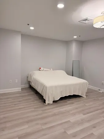 a bedroom with a bed and a night stand