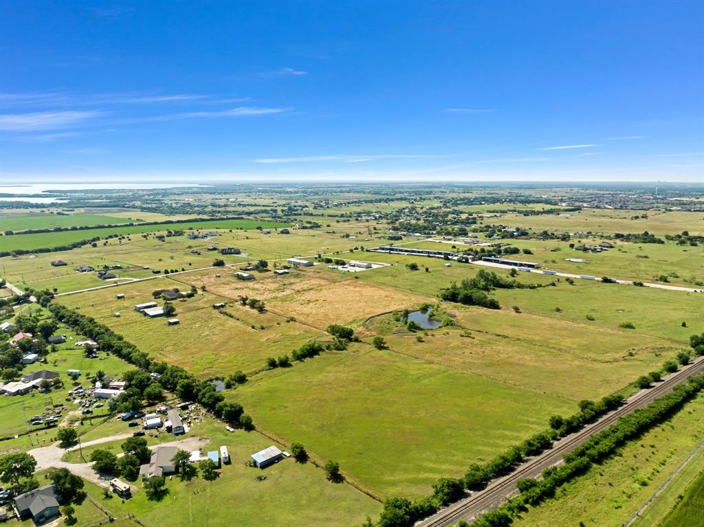 1795 Melton Road Sanger, TX 76266 - Photo 10 of 17 Expansive rural landscape featuring extensive green fields and scattered residential properties under a clear sky