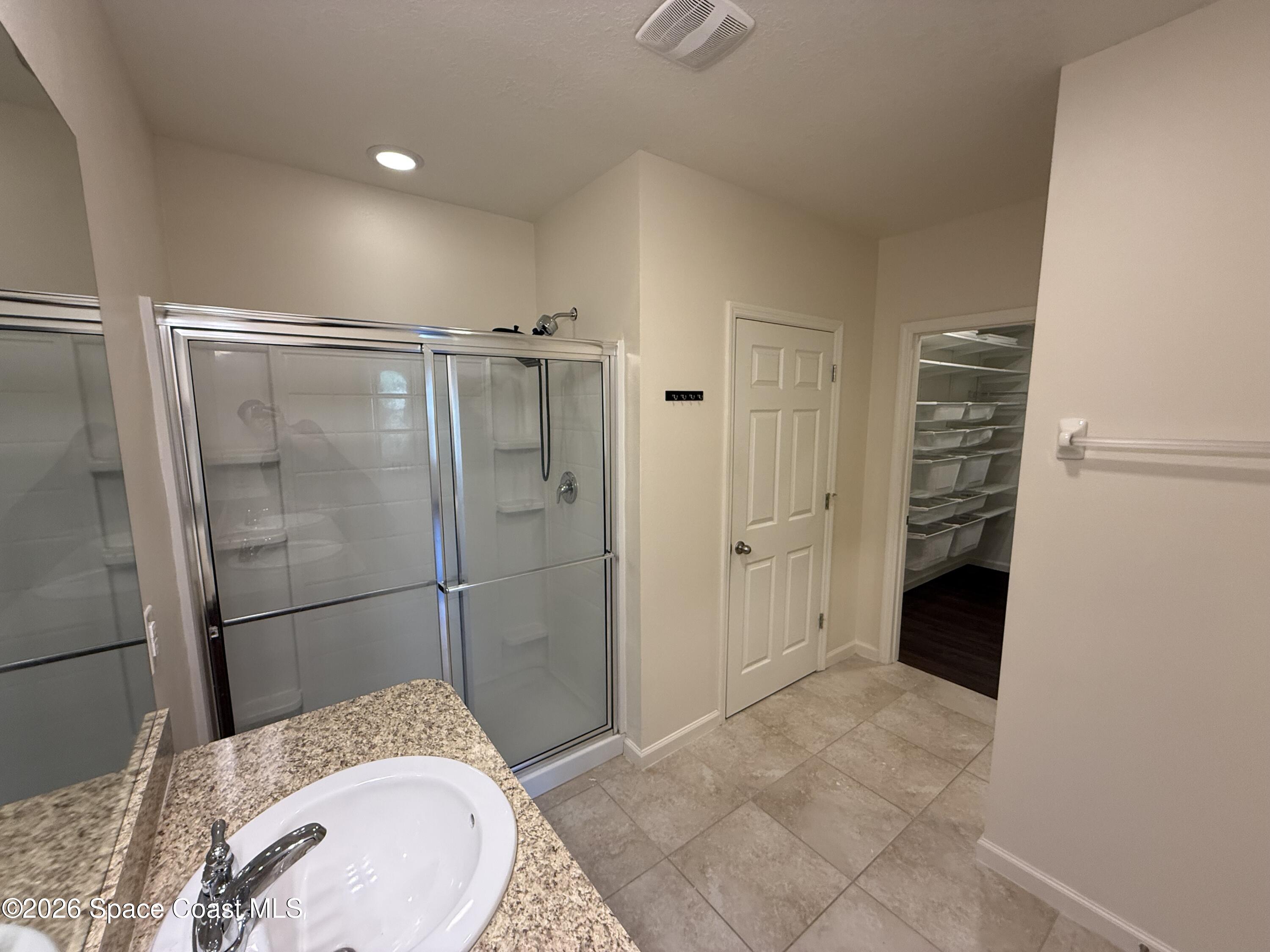 1070 Swiss Pointe Lane Rockledge, FL 32955 - Photo 16 of 18 a bathroom with a granite countertop sink a shower and a mirror