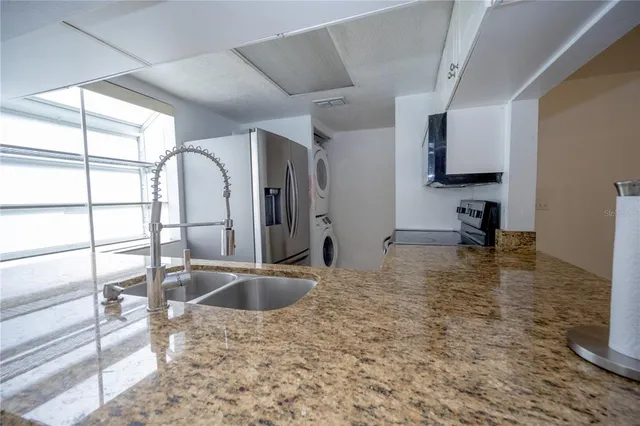 a kitchen with sink cabinets and outdoor view