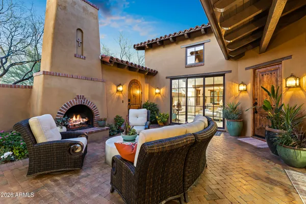 a front view of a house with outdoor seating