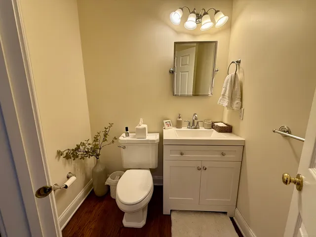 a bathroom with a sink vanity mirror and toilet