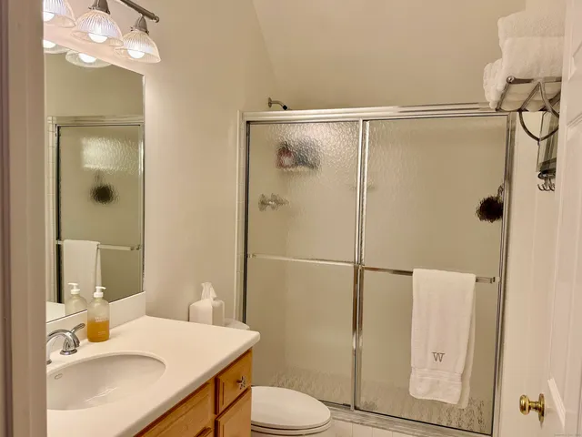 a bathroom with a sink toilet and shower