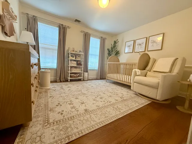 a living room with a couch and a refrigerator