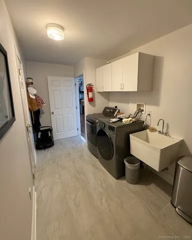 a view of a storage & utility room with two washing machine